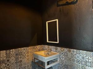 a bathroom with a sink and a mirror at Mulan Guest House with Forest Bathtub in Pantai Cenang +28 photos