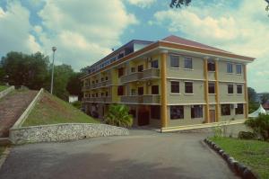 a large yellow building on the side of a road at City Times Hotel in Kuantan