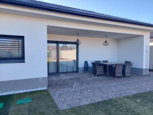 a patio with a table and chairs in a house at Villa Holiday Hevlín in Hevlín