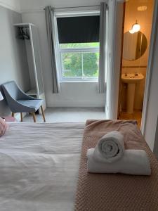 a bedroom with a bed with a towel on it at Newton House in Alstonfield