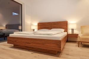 a bedroom with a large bed and a chair at The Hills in Merano