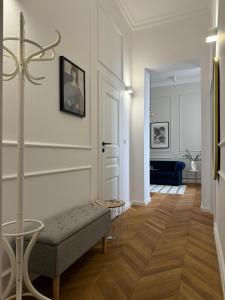 a living room with a bench and a hallway at Wilson Apartamenty in Poznań