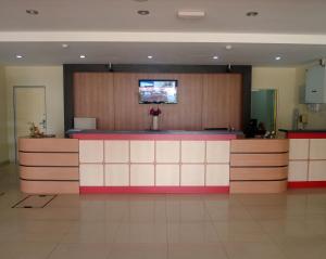 a lobby with a bar with a tv on the wall at City Times Hotel in Kuantan