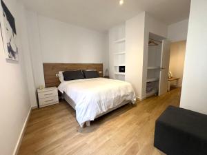a bedroom with a white bed and a wooden floor at Marbella Old Town Apartments by Homing in Marbella