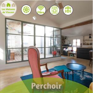 Perchoir - Terrasse في آرل: غرفة معيشة بها نوافذ وطاولة وكراسي