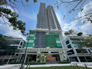 a tall building with a sign in front of it at MONIC STAYCATION #Southkey Mosaic next to Mid Valley Mall in Johor Bahru