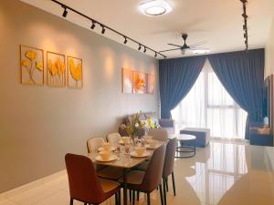 a dining room with a table and chairs at MONIC STAYCATION #Southkey Mosaic next to Mid Valley Mall in Johor Bahru