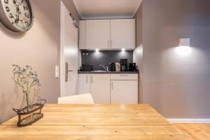 a kitchen and dining room with a wooden table at Logierhaus K15 Appartement 1 in Borkum