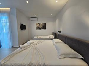 a bedroom with two beds in a room at Adele Hotel Ksamil in Ksamil
