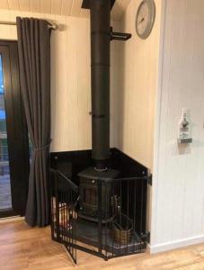 a stove in the corner of a room at Gorestown Glamping Chalets in Drummond