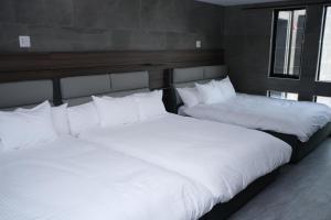 A bed or beds in a room at プラフィーノリゾートヴィラ