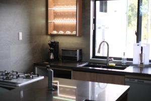 A kitchen or kitchenette at プラフィーノリゾートヴィラ