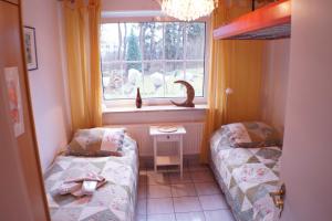 Ein Bett oder Betten in einem Zimmer der Unterkunft Graf Luckner Hüs