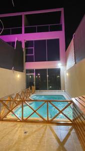 a large swimming pool in front of a building at night at درة العروس فيلا بشاطئ رملي خاص in Durat  Alarous