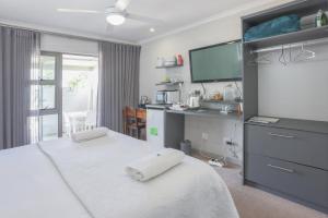 a bedroom with a bed with two white towels on it at Lily's Rest, Village on Silwerstrand, Robertson in Robertson