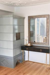 a dressing table with a mirror on a wall at The R Apartment Cholfirst in Schaffhausen