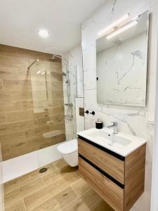 a bathroom with a sink and a toilet and a shower at Perseo by Albir Proper Properties in Albir +15 photos