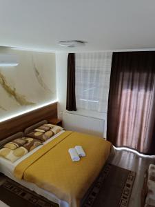 A bed or beds in a room at Boglárka Vendégház