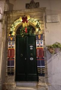 a black door with a christmas decoration on it at Il Cortile nel Borgo in Lanciano