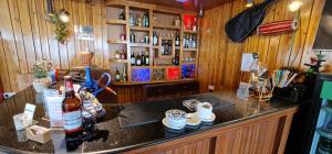 a bar with bottles of alcohol on a counter at East On Blue Hotel in Ilām