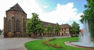 a large building with a fountain in front of it at La Casa de Hugo in Colmar