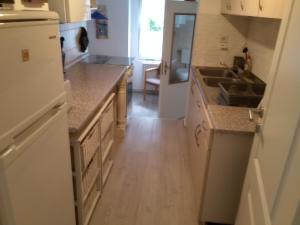 a kitchen with white cabinets and a sink at Ferienhaus Schatz in Siedlung Schönwalde