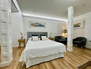 a bedroom with a bed and two chairs in it at LOFT CENTRE SANTANDER in Santander