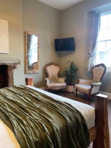 a bedroom with a bed and a living room at The Roost in Cullompton