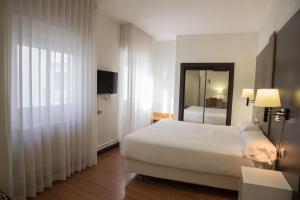 Postel nebo postele na pokoji v ubytování Hotel Delta