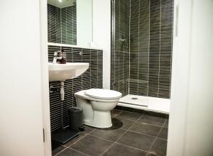 a bathroom with a toilet and a sink at Close To Leeds City, Spacious, Sleeps 4, in Beeston Hill