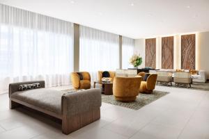 a living room with a couch and chairs at AC Hotel by Marriott Honolulu in Honolulu