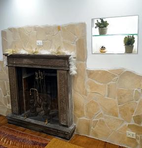 sala de estar con chimenea y pared de piedra en Il Rifugio di Piazza dell' Oca en Ronciglione