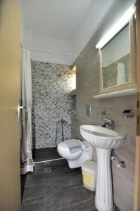 a bathroom with a sink and a toilet at PALEOCHORA FINIKAS Apartments in Palaiochóra