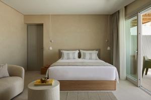 a bedroom with a large bed and a couch at PAROCKS Luxury Hotel & Spa in Ambelas