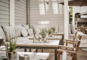an outdoor patio with tables and chairs and a glass jar at The Cozy Hotel & Lofts Timmendorfer Strand in Timmendorfer Strand