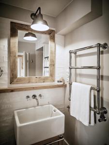 a bathroom with a sink and a mirror at The Cozy Hotel & Lofts Timmendorfer Strand in Timmendorfer Strand