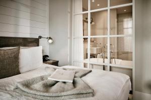 a bedroom with a bed with a towel on it at The Cozy Hotel & Lofts Timmendorfer Strand in Timmendorfer Strand