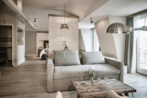 a living room with a couch and a table at The Cozy Hotel & Lofts Timmendorfer Strand in Timmendorfer Strand
