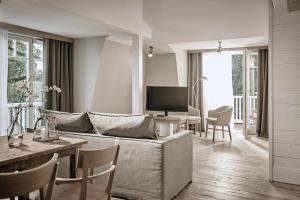 a living room with a couch and a table at The Cozy Hotel & Lofts Timmendorfer Strand in Timmendorfer Strand