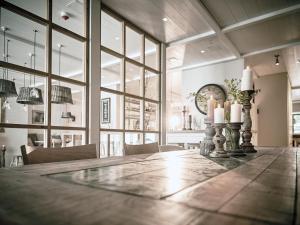 a large dining room with a long table with candles at The Cozy Hotel & Lofts Timmendorfer Strand in Timmendorfer Strand