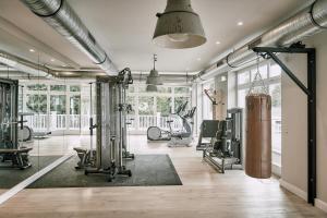 a gym with several treadmills and exercise equipment at The Cozy Hotel & Lofts Timmendorfer Strand in Timmendorfer Strand