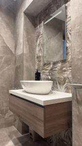 a bathroom with a white sink and a mirror at Fronte lago nel centro storico “La Casa del Lago” in Trevignano Romano