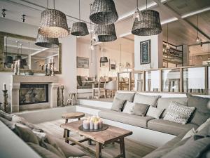 a living room with a couch and a table at The Cozy Hotel & Lofts Timmendorfer Strand in Timmendorfer Strand