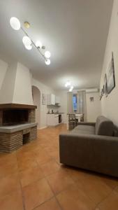 a living room with a couch and a fireplace at Fronte lago nel centro storico “La Casa del Lago” in Trevignano Romano