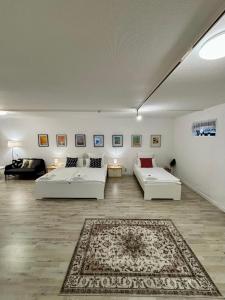 a living room with two beds and a rug at Quartier Wenzelnberg work&stay in Langenfeld