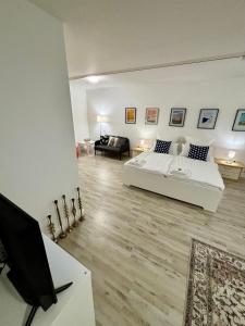 a living room with a bed and a couch at Quartier Wenzelnberg work&stay in Langenfeld