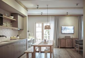 a kitchen with a table and a dining room at The Cozy Hotel & Lofts Timmendorfer Strand in Timmendorfer Strand