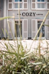 a white building with a gayuana sign on it at The Cozy Hotel & Lofts Timmendorfer Strand in Timmendorfer Strand