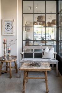 a room with benches and tables in a store at The Cozy Hotel & Lofts Timmendorfer Strand in Timmendorfer Strand