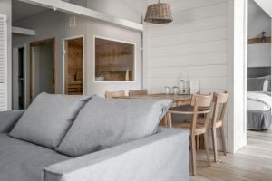 a living room with a couch and a table at The Cozy Hotel & Lofts Timmendorfer Strand in Timmendorfer Strand